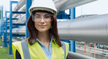 Ladie wearing PPE working at a chemical plant
